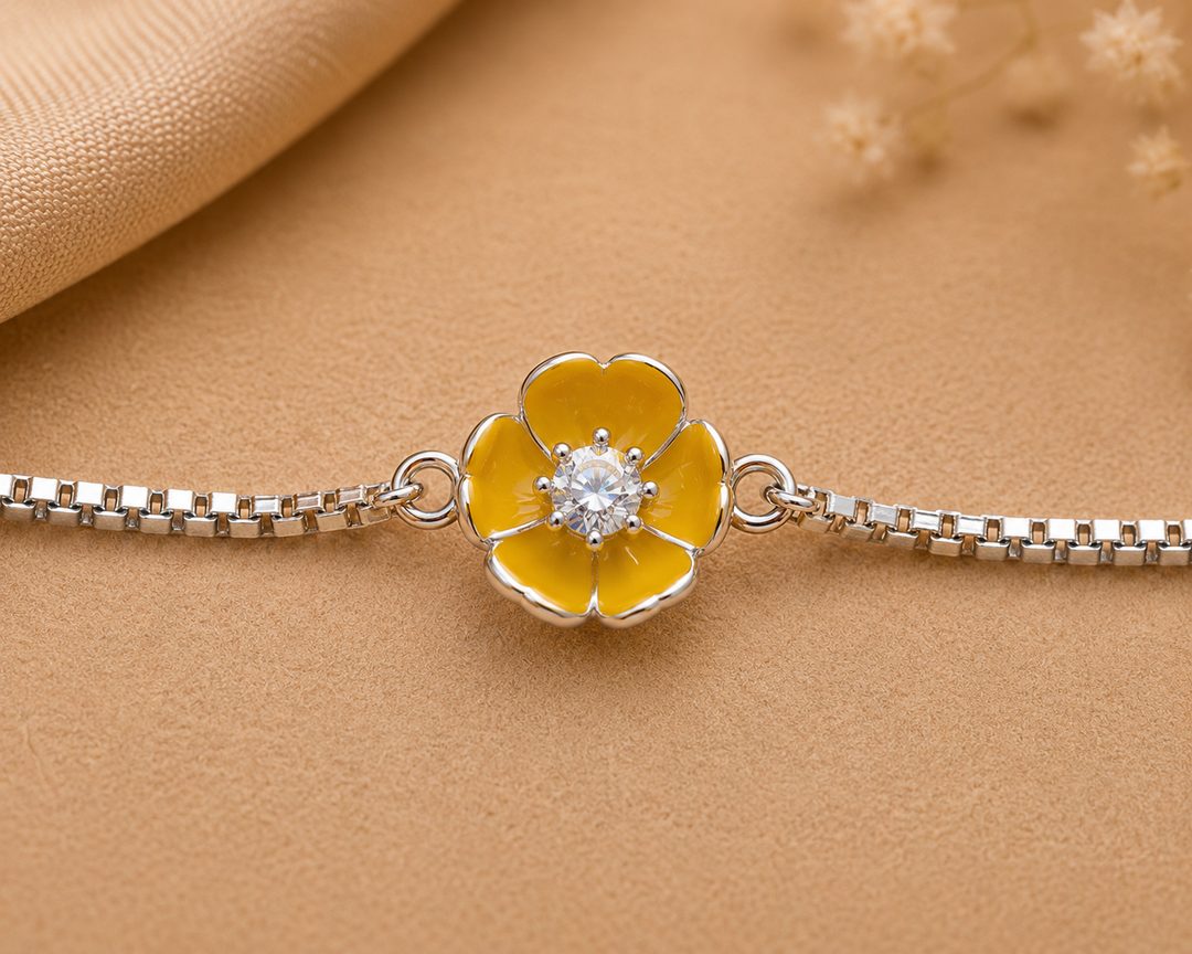 A sterling silver bracelet featuring a yellow enamel flower charm with a sparkling CZ center, displayed on a plain background.